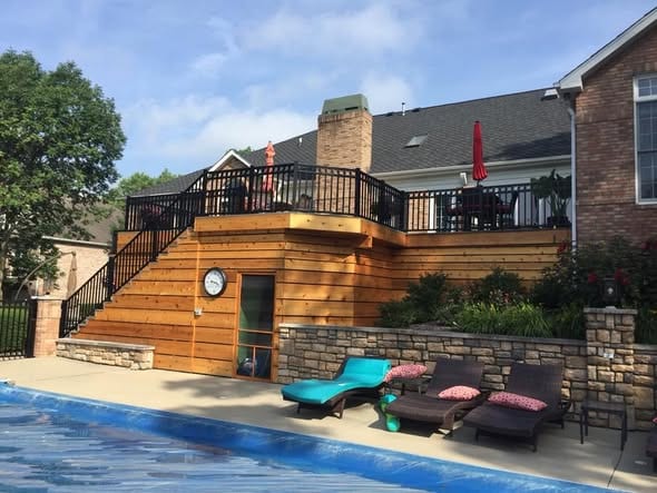 Black aluminum railing on a two-story cedar pool deck