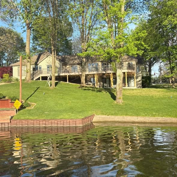 Lakefront home with new deck railings seen from the water