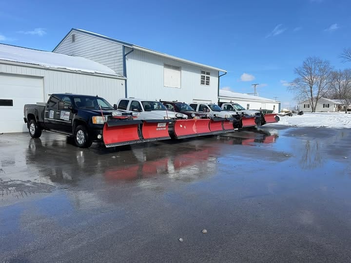 Effingham Fence and Railing plow truck fleet lined up outside the shop